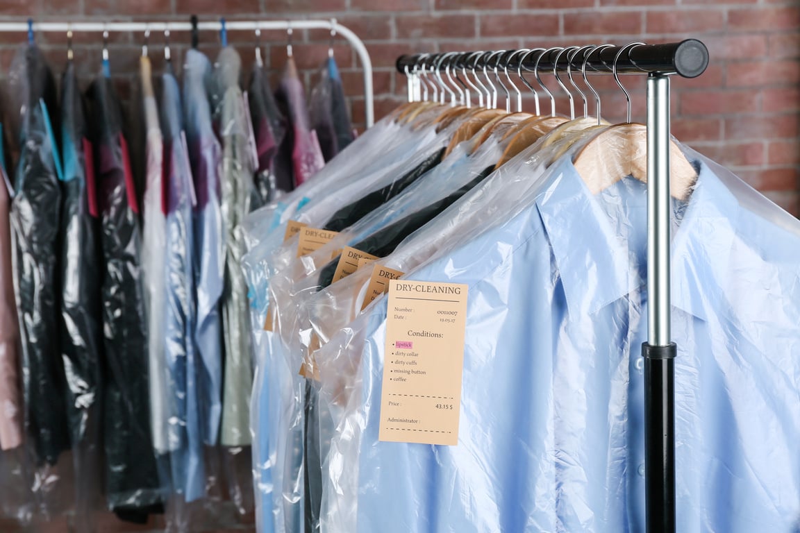 Rack of Clean Clothes Hanging at Dry Clean Service